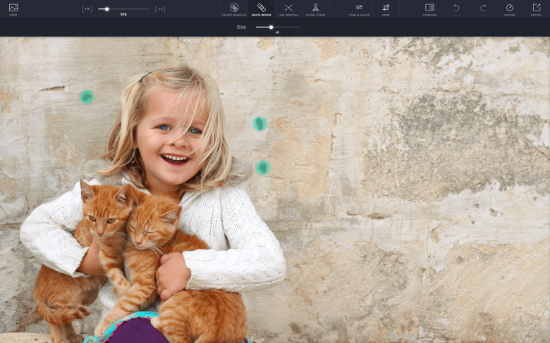 Remove small items from photos by drawing over them with your finger.
